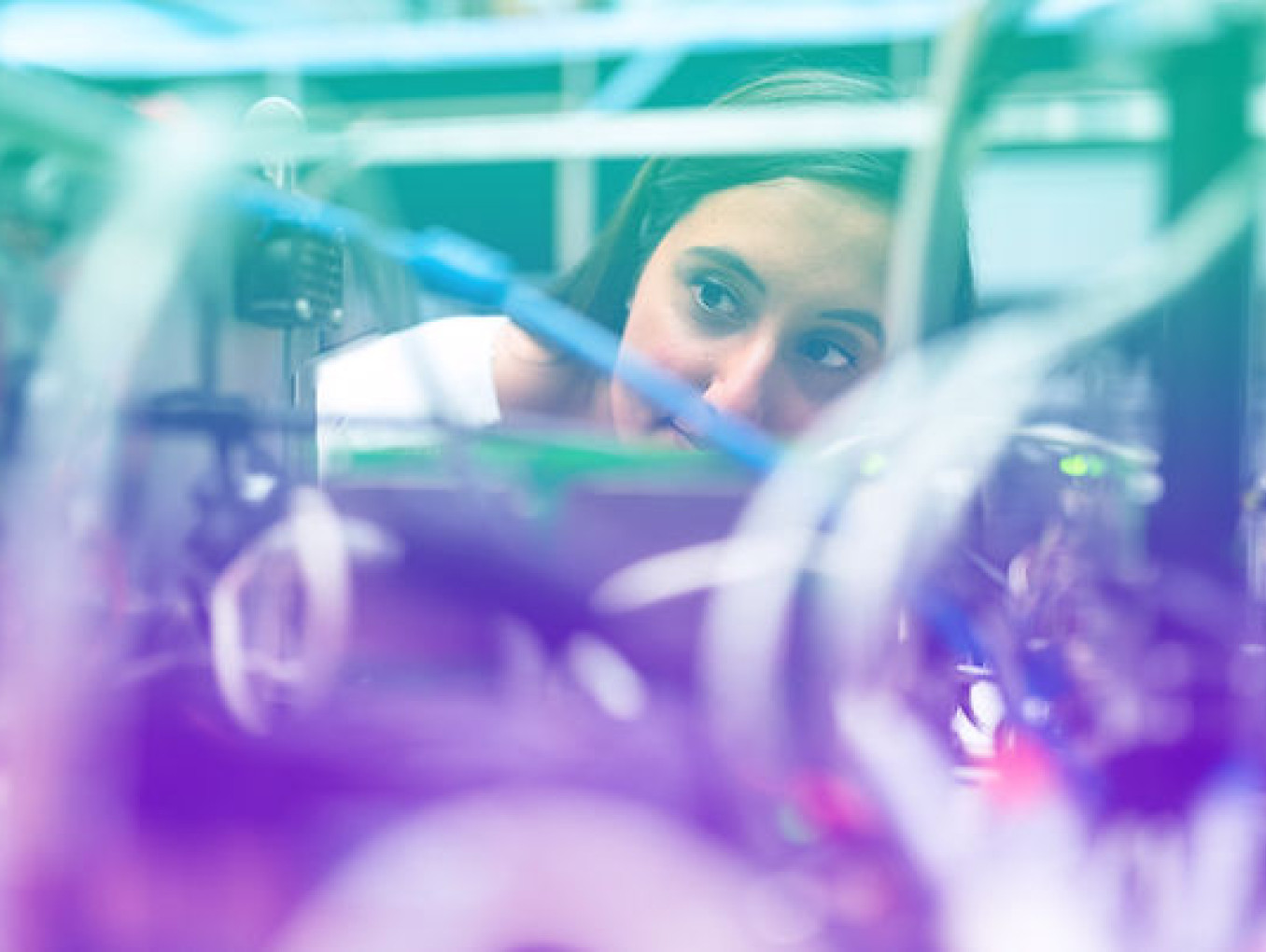A woman looking at a circuit