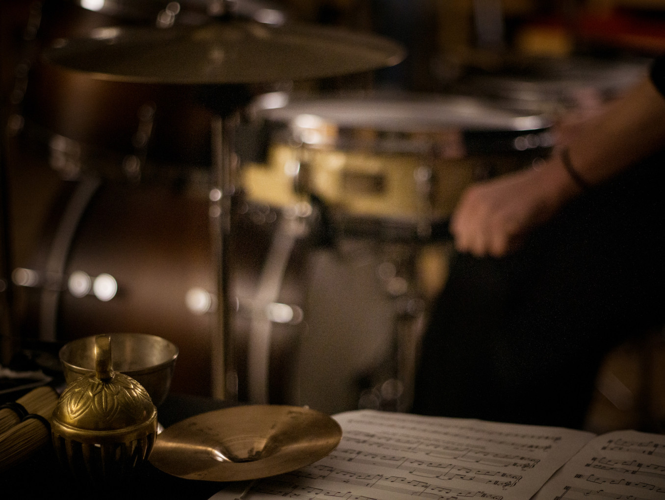 A set of drums with sheet music in front.
