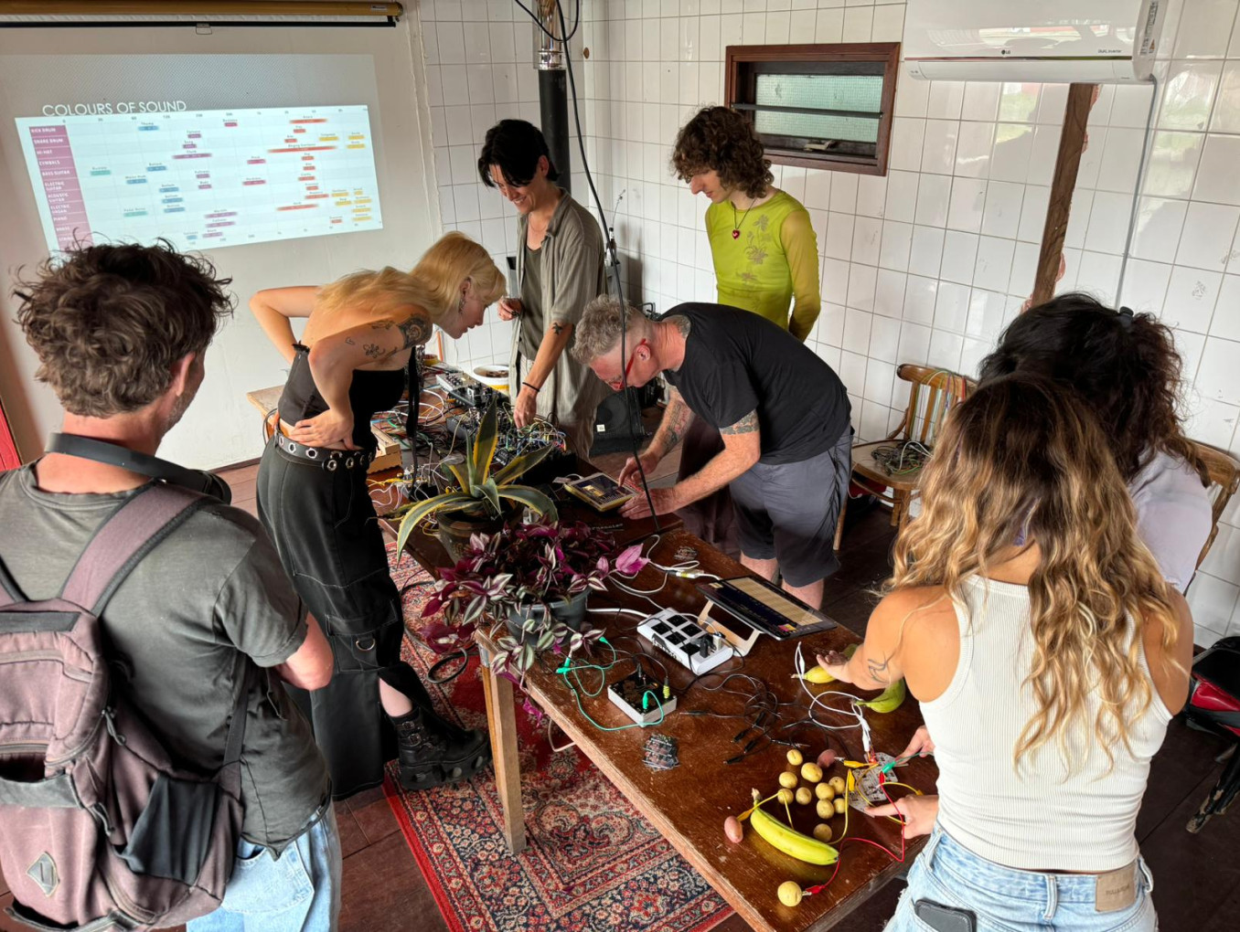 People around a table making sounds with plants and heartbeats