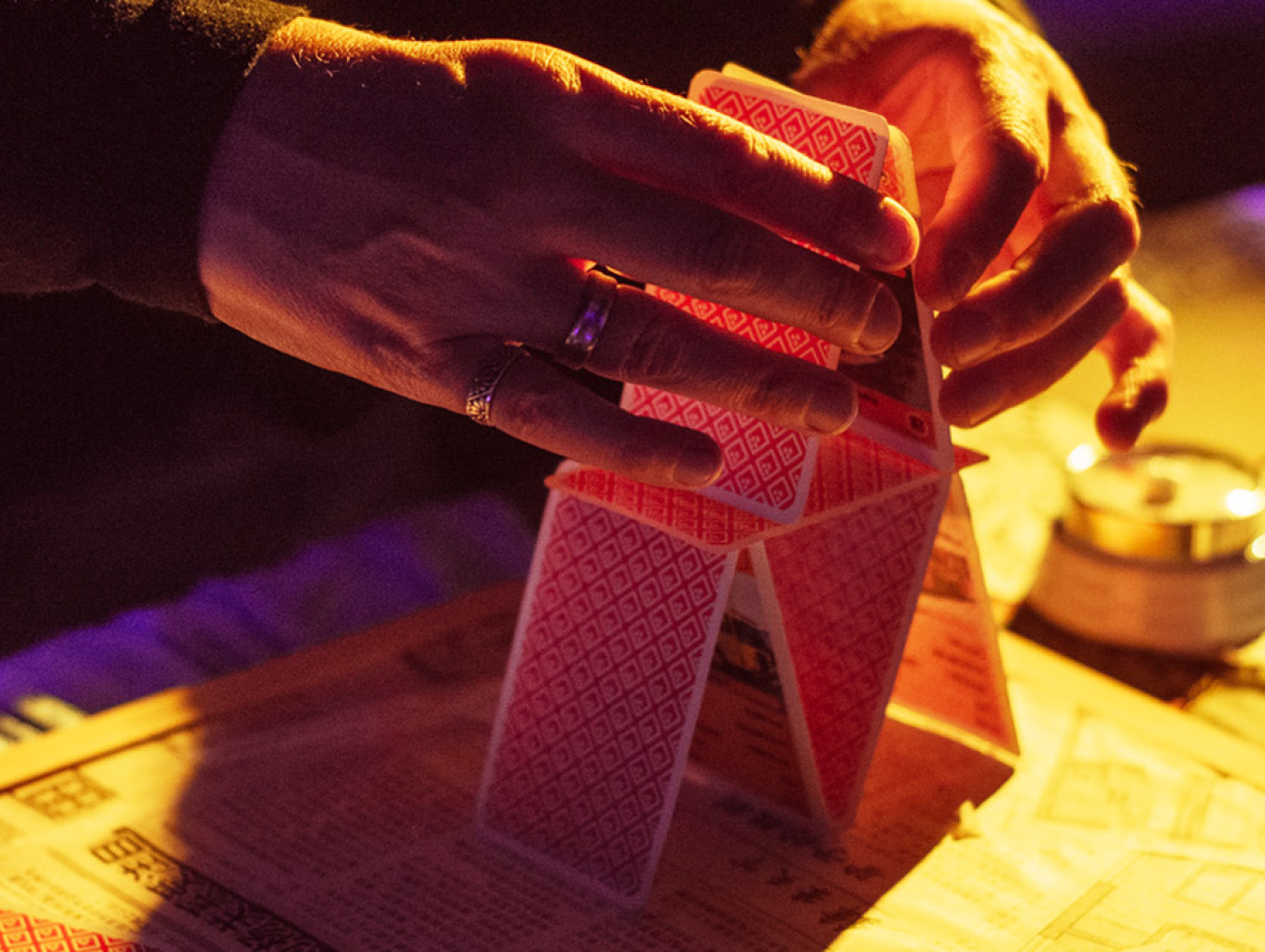 hands building a house of cards