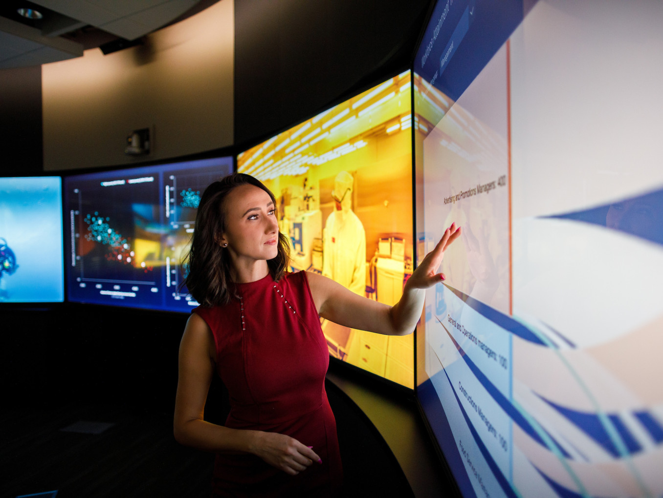 A woman taps a screen of the Decision Theater 