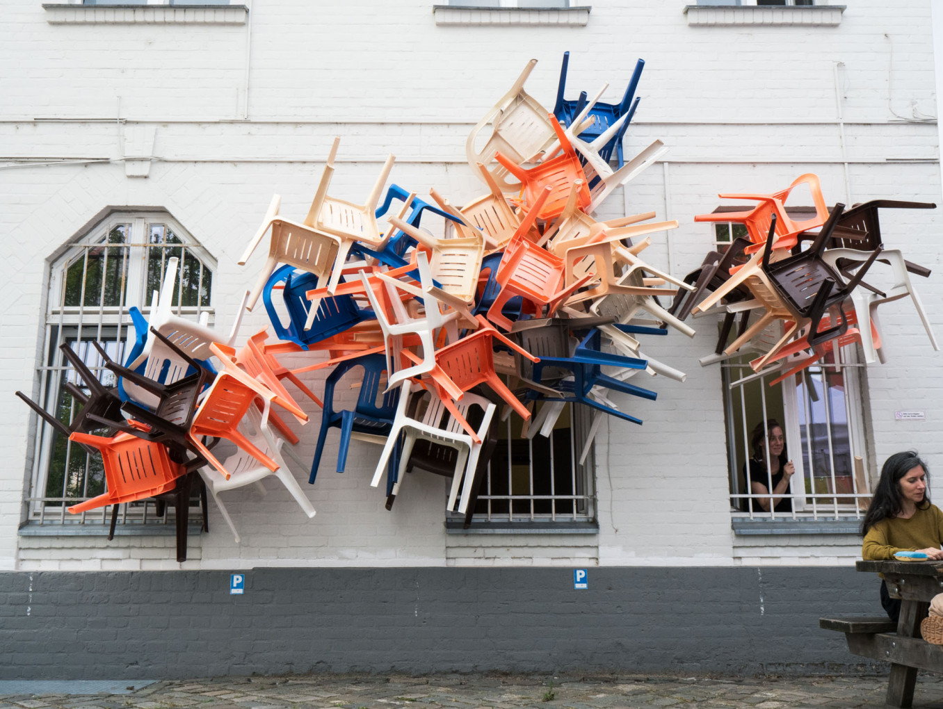 Chairs coming out of windows.