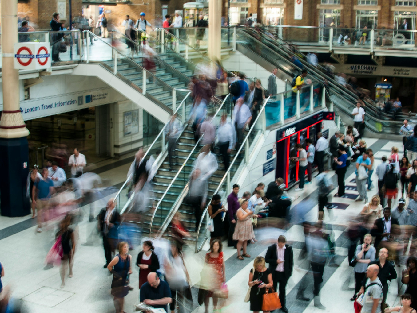 Blurred people walking through a train station. 