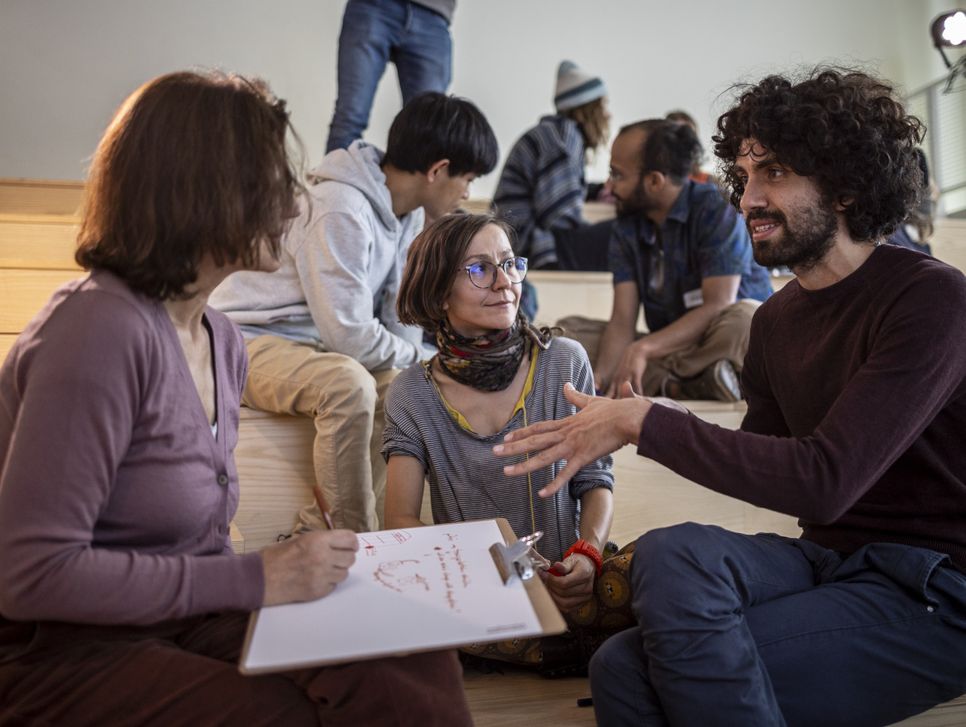 A group sits together brainstorming.