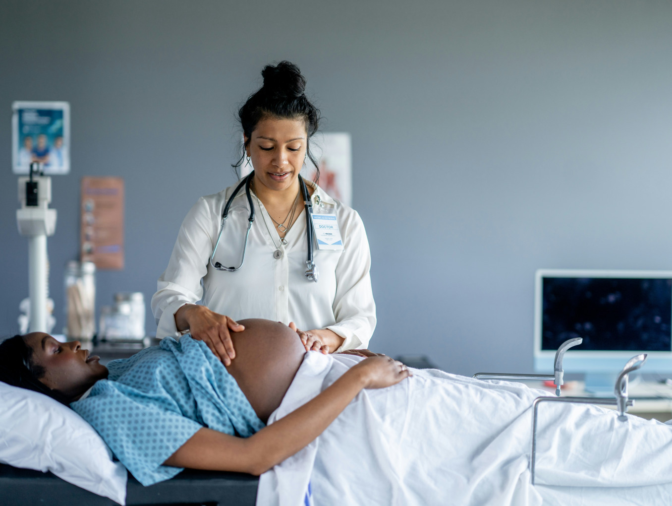 A pregnant woman receives prenatal care. 