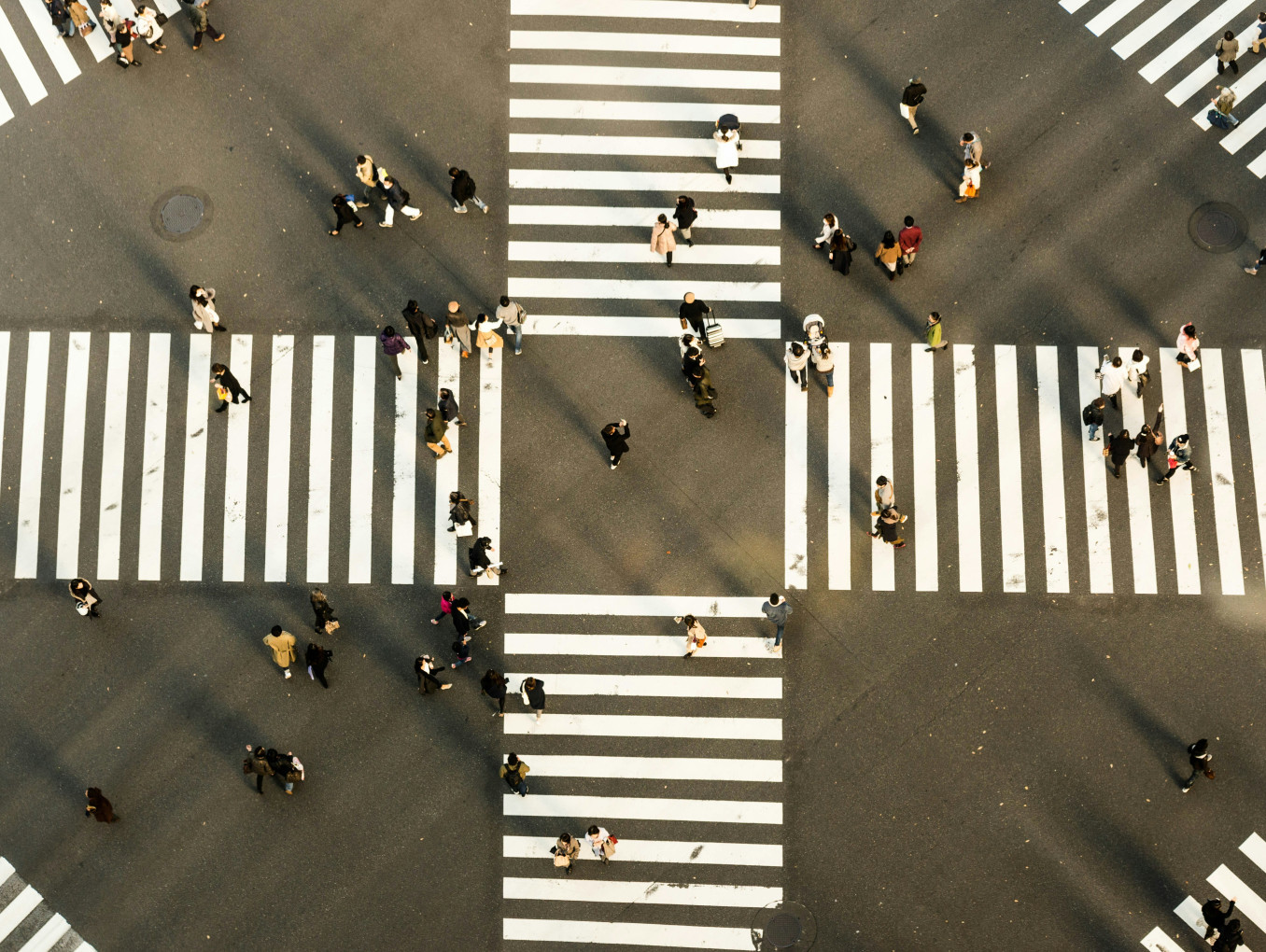 Aerial view of people crossing a street. 