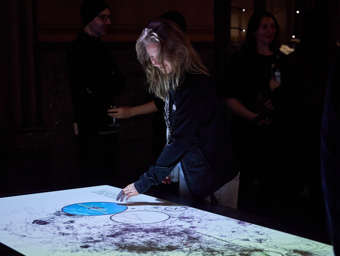 A woman touches a screen