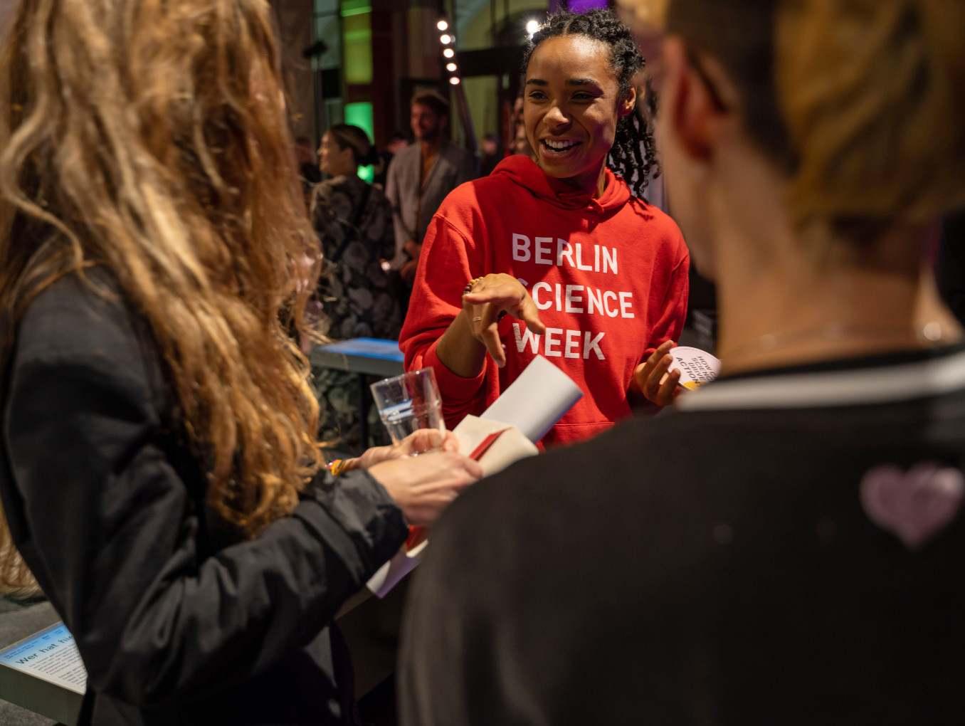 A volunteer chats to guests at an event. 