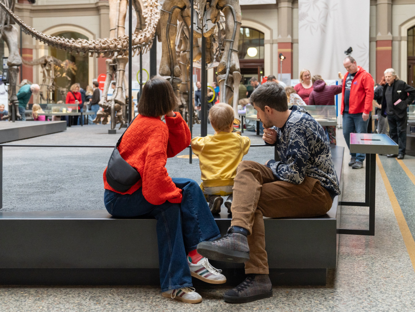 A family sits at a museum 