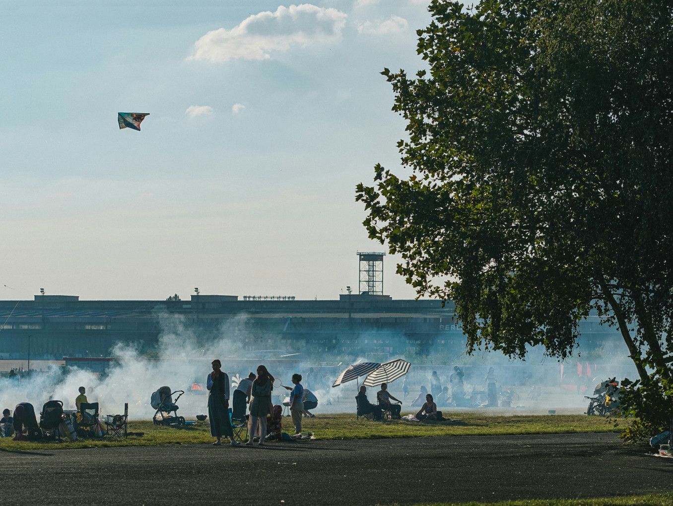 A group of people stand on Templerhoferfeld, Berlin.