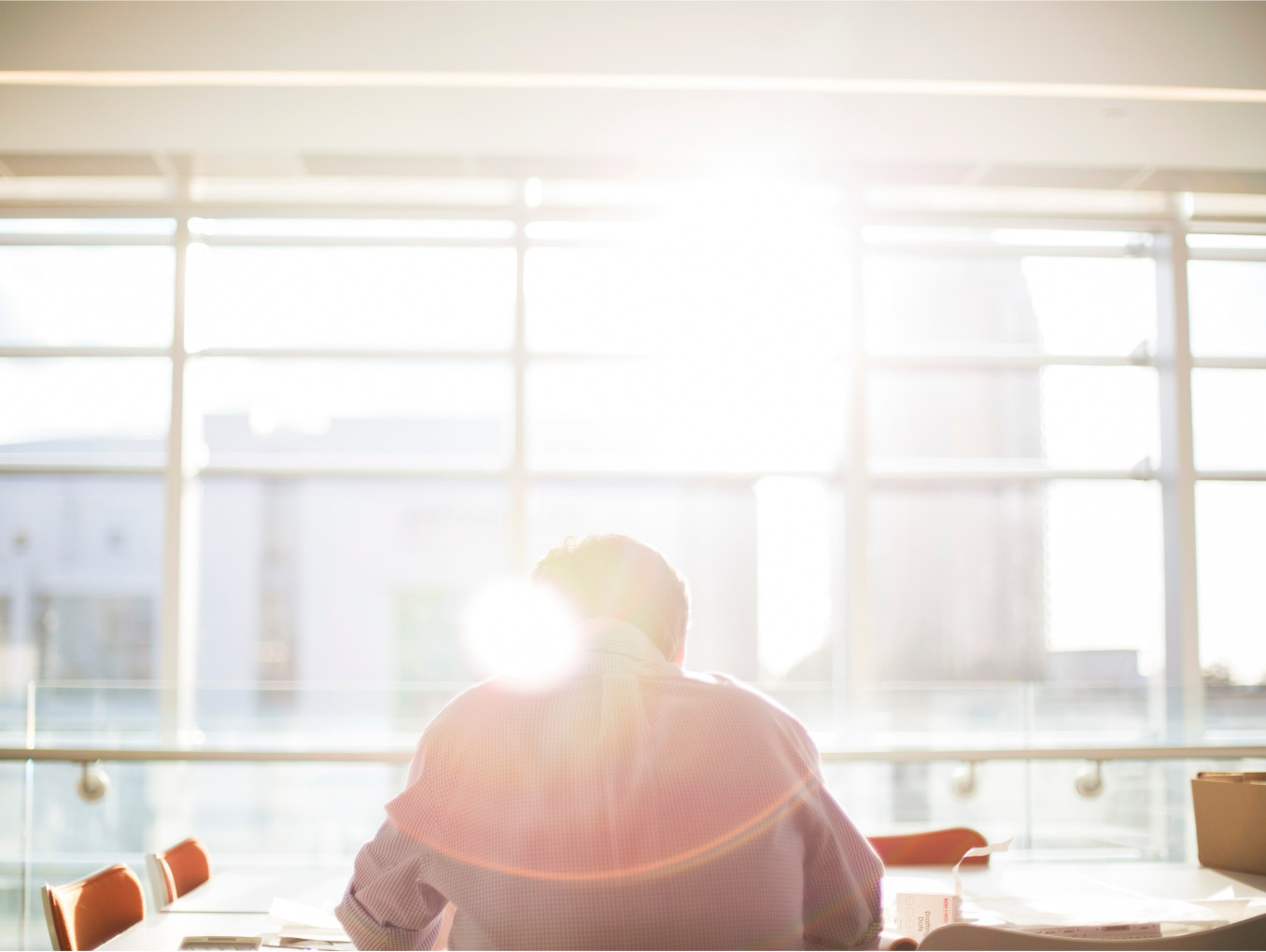 Sunlight through the windows, a man sitting there