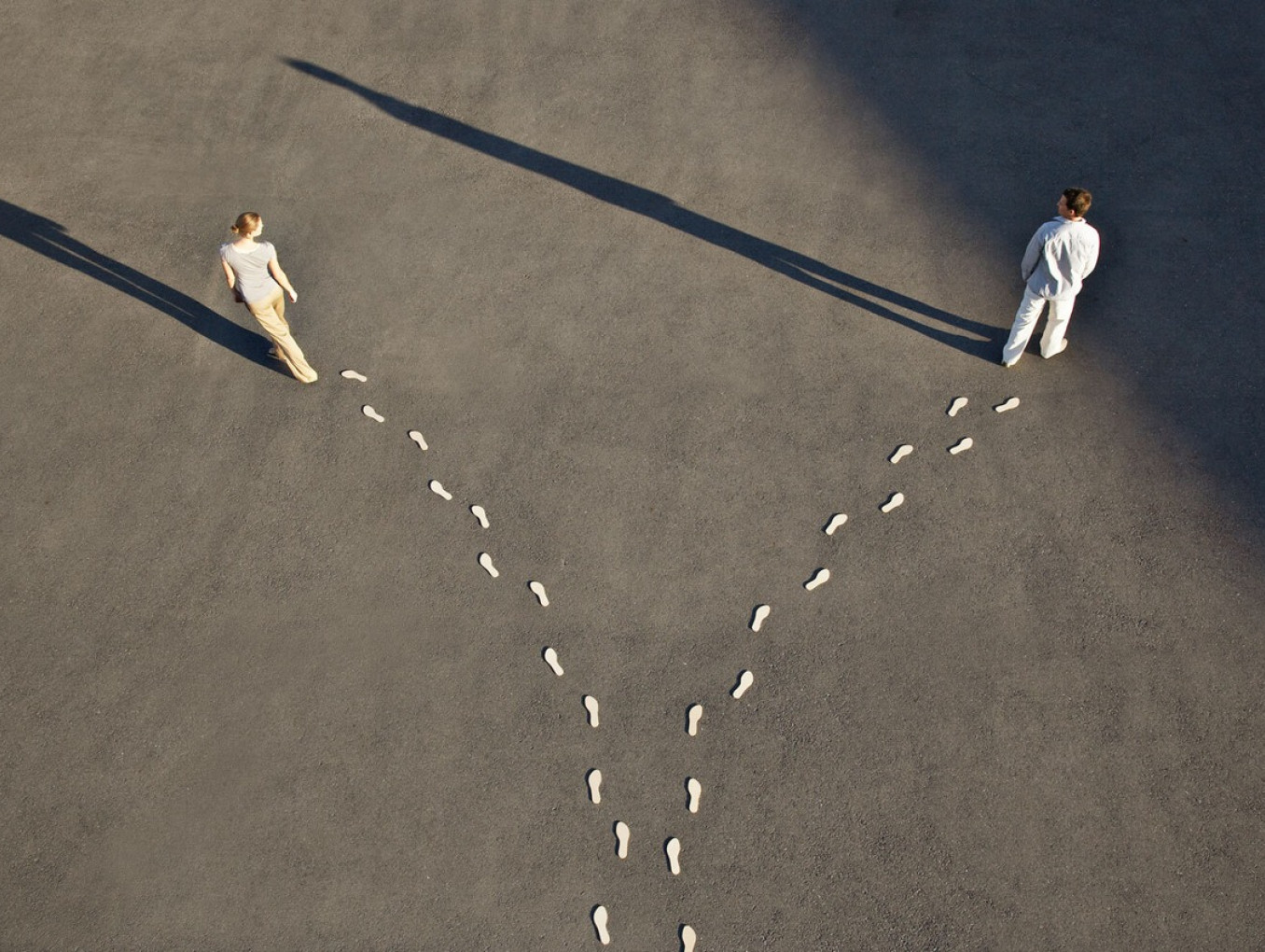 Two people walking in different directions.