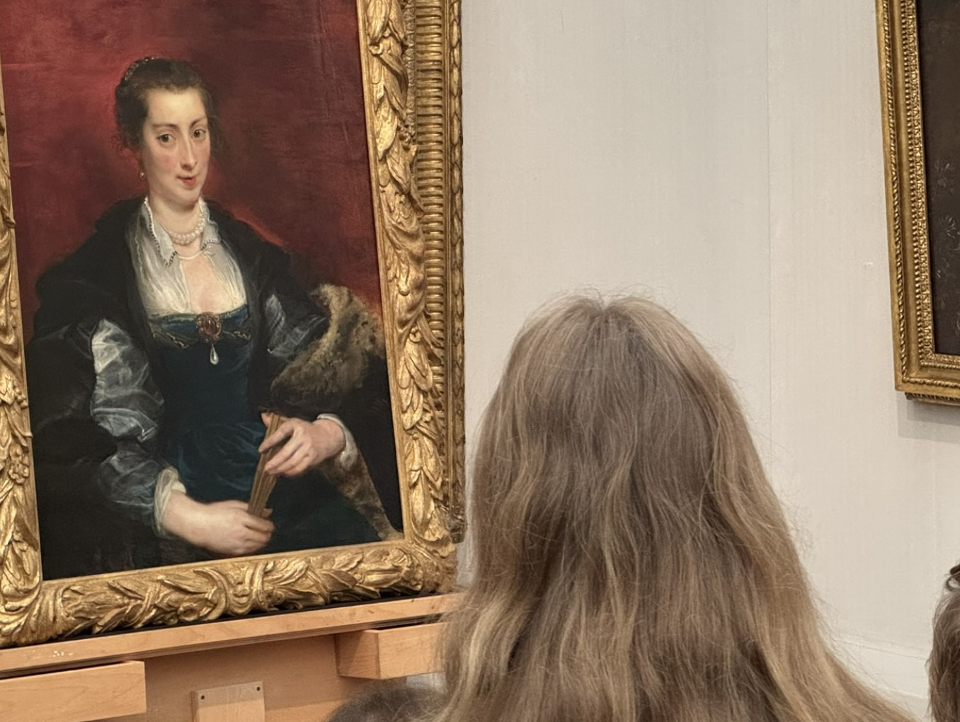 Person looking at an oil painting