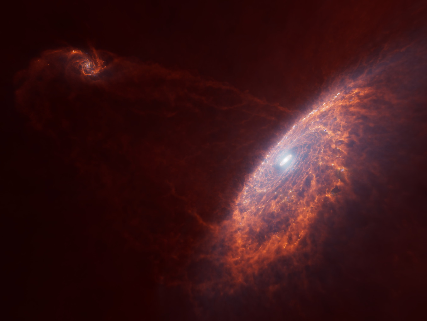 Zwei rätliche Spiralgalaxien, eine im Vordergrund rechts, eine links hinten, die sich aufeinander zu bewegen.