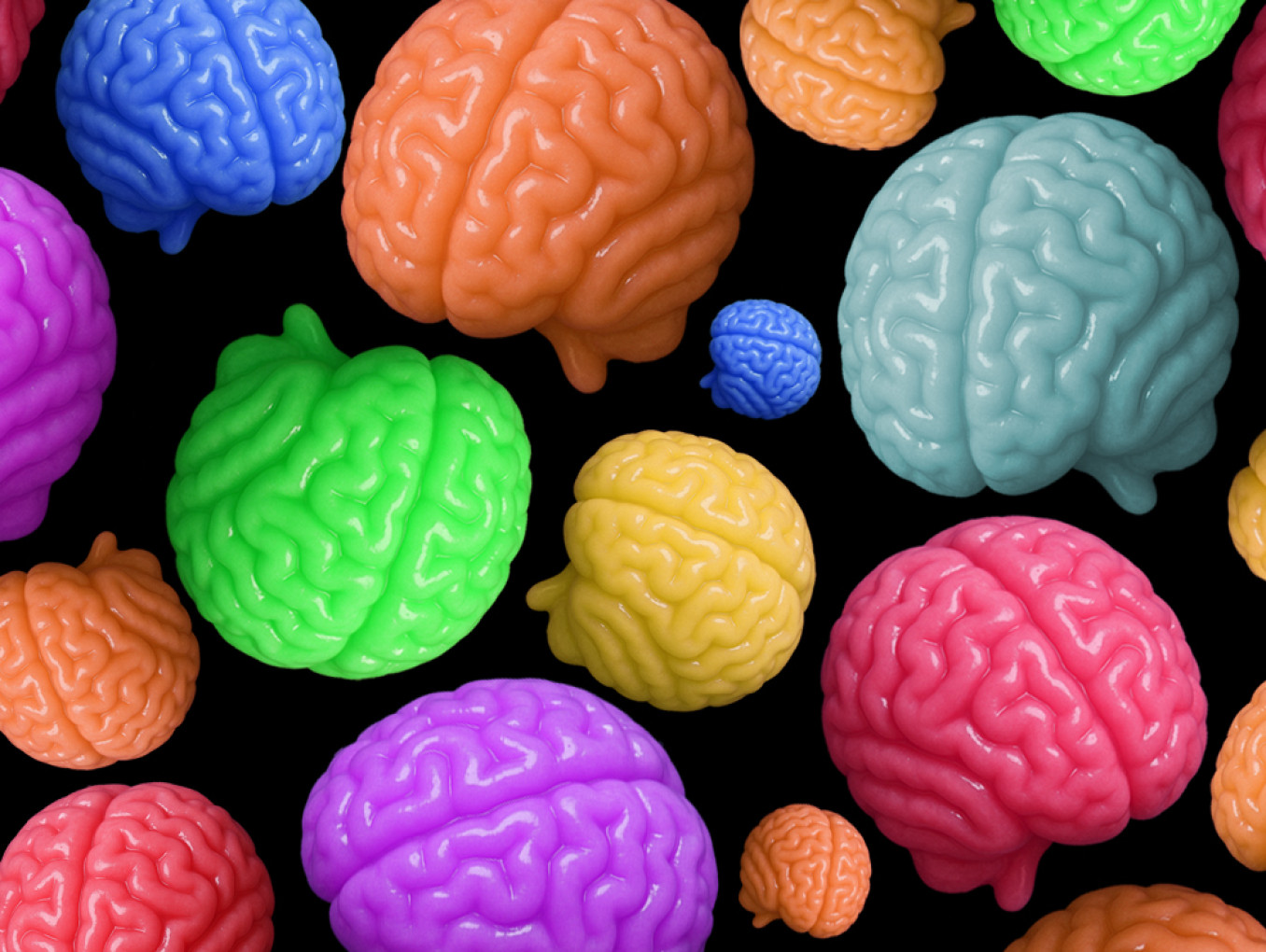 Little gummy brains of different colors and sizes on top of a black background