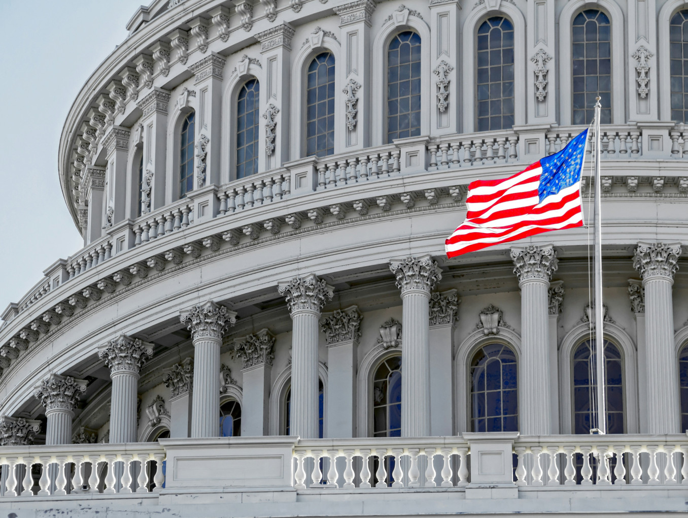 US flag flying on the US Capitol Building