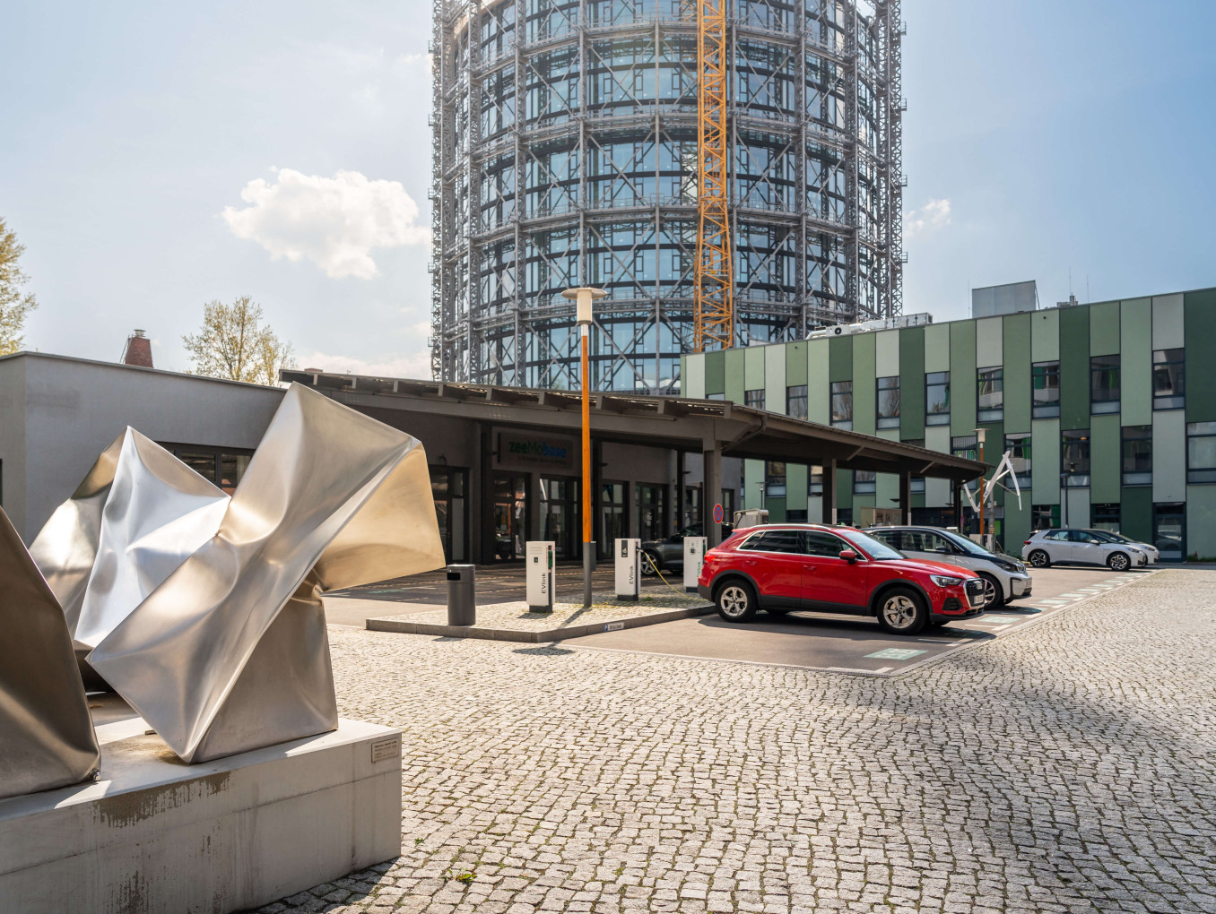 Photo of car park and entrance to zeemobase with abstract statue