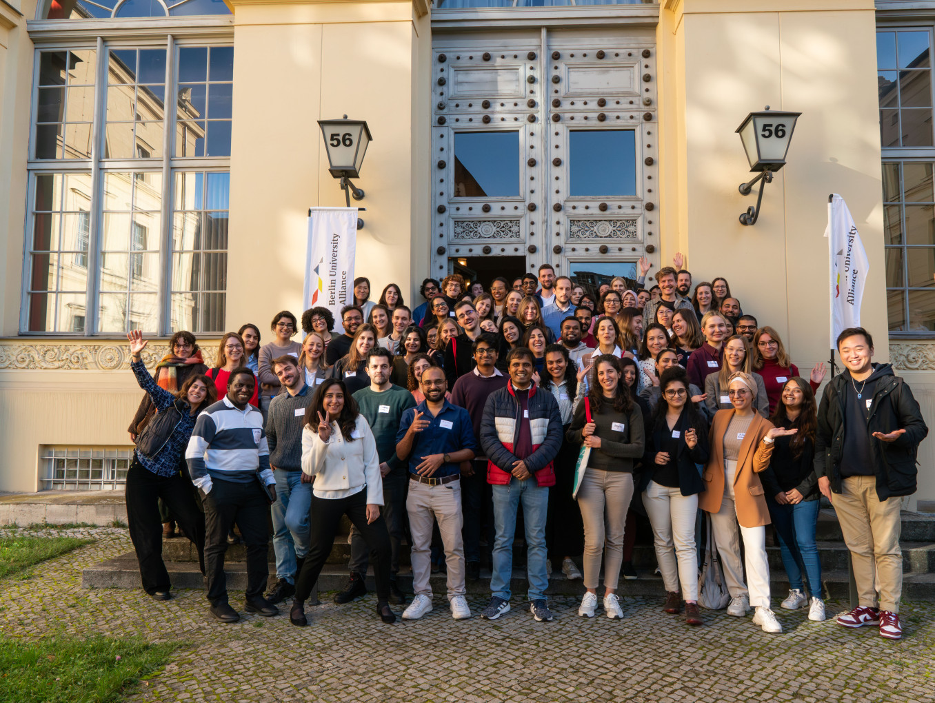 Group photo of Berlin Postdoc Day 2025 participants in front of the entrance of Humboldt Graduate School building