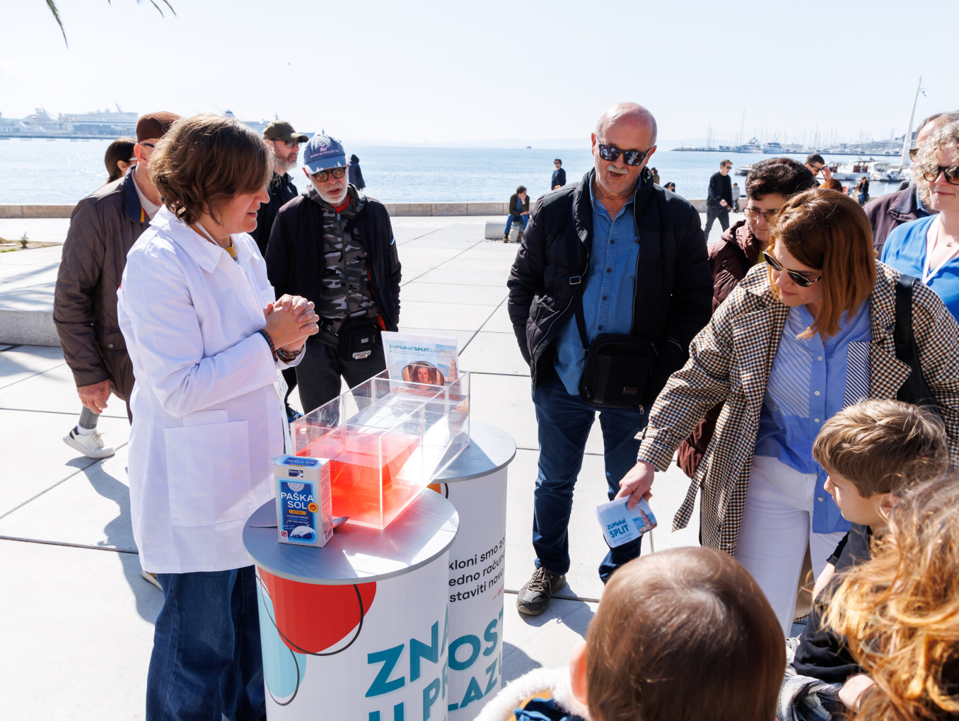 Scientist presenting work at a stand in a public place