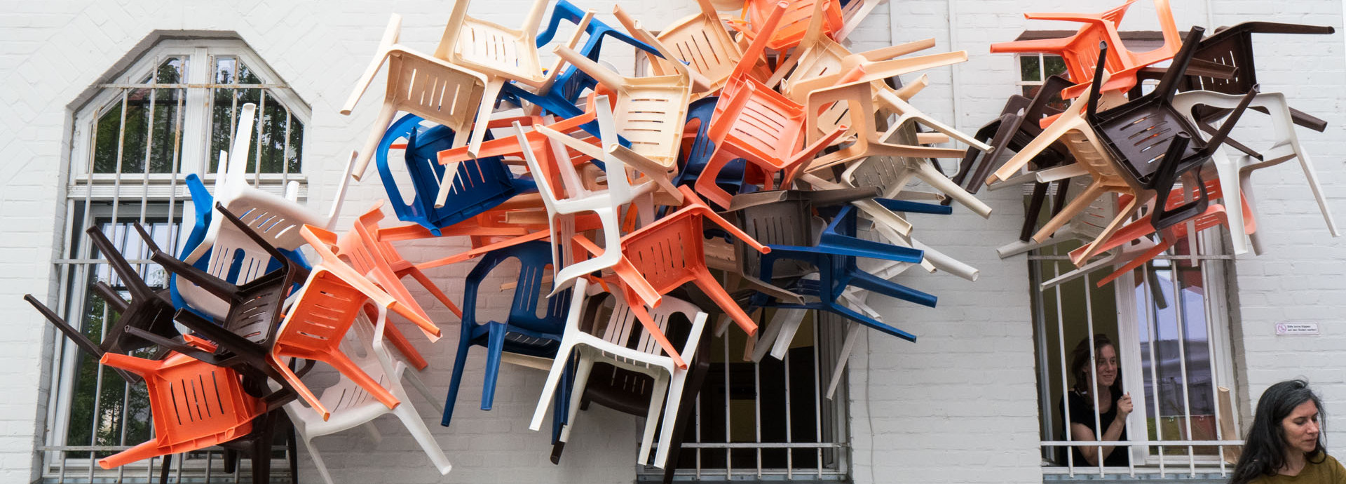 Chairs coming out of windows.