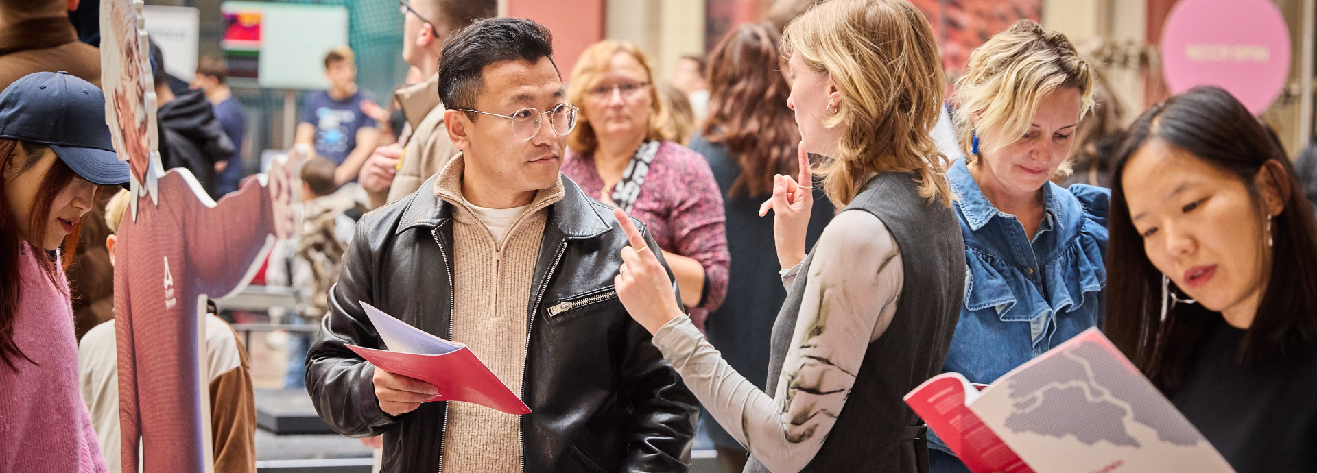 Two people speaking in a museum