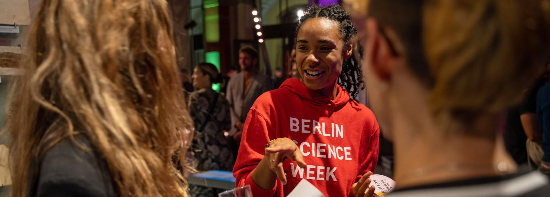 A volunteer chats to guests at an event. 