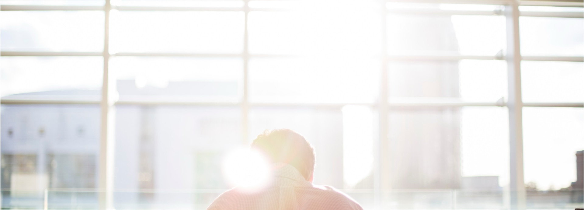 Sunlight through the windows, a man sitting there