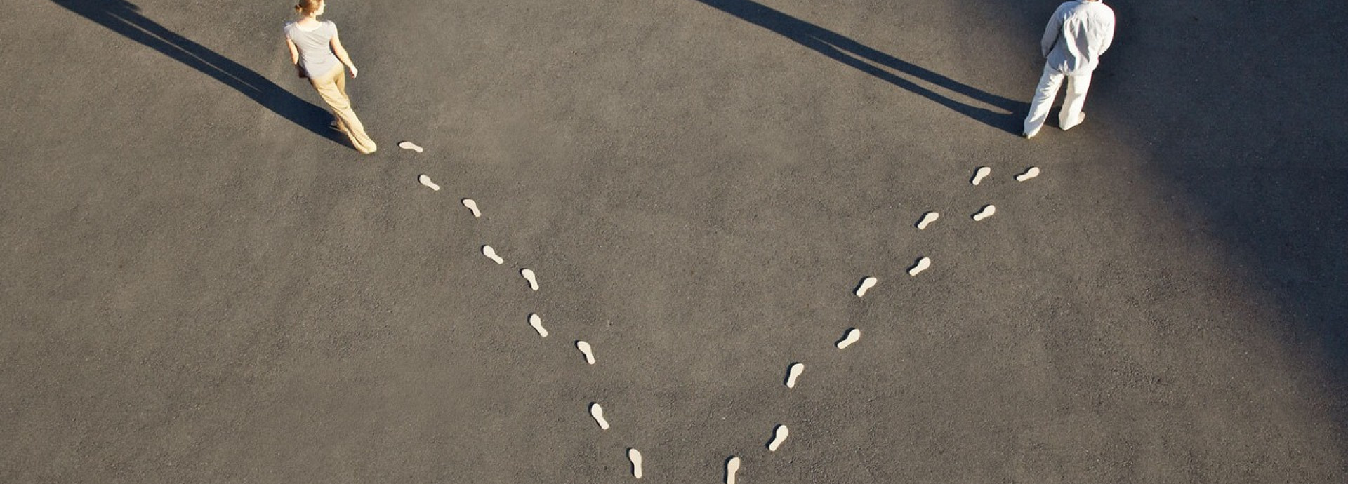 Two people walking in different directions.