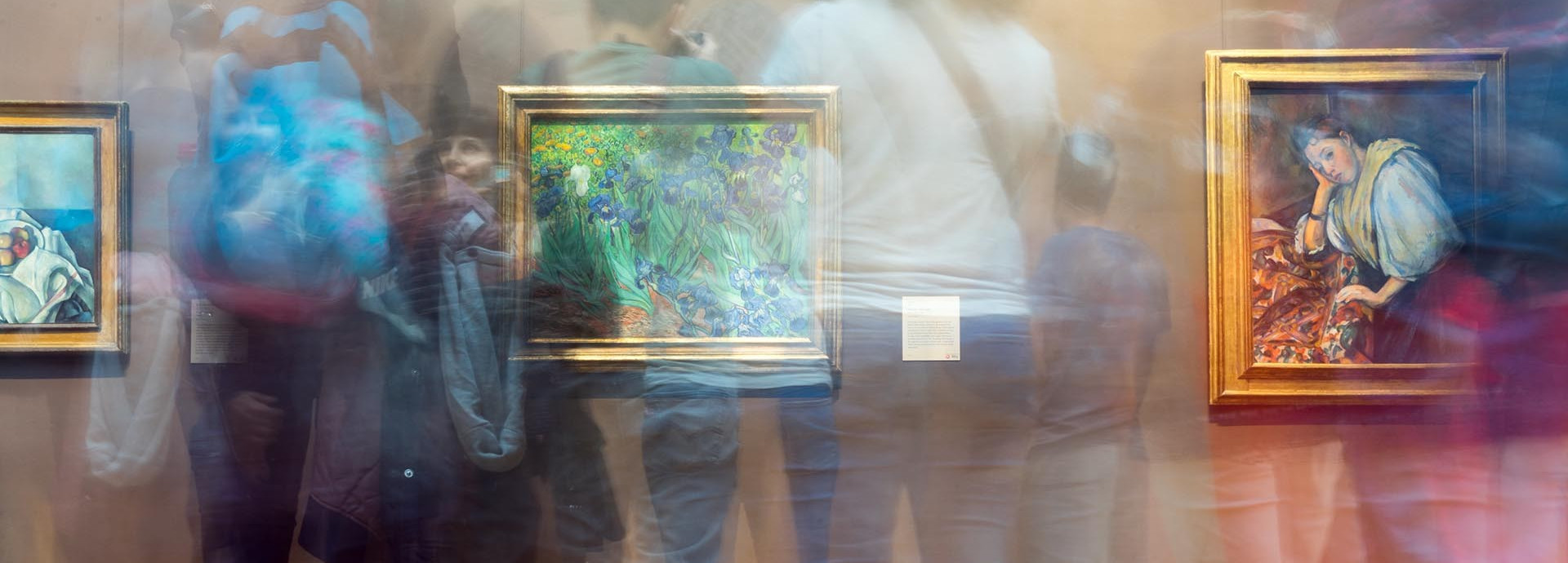 Double-exposure shadows of people in a gallery space with impressionist paintings