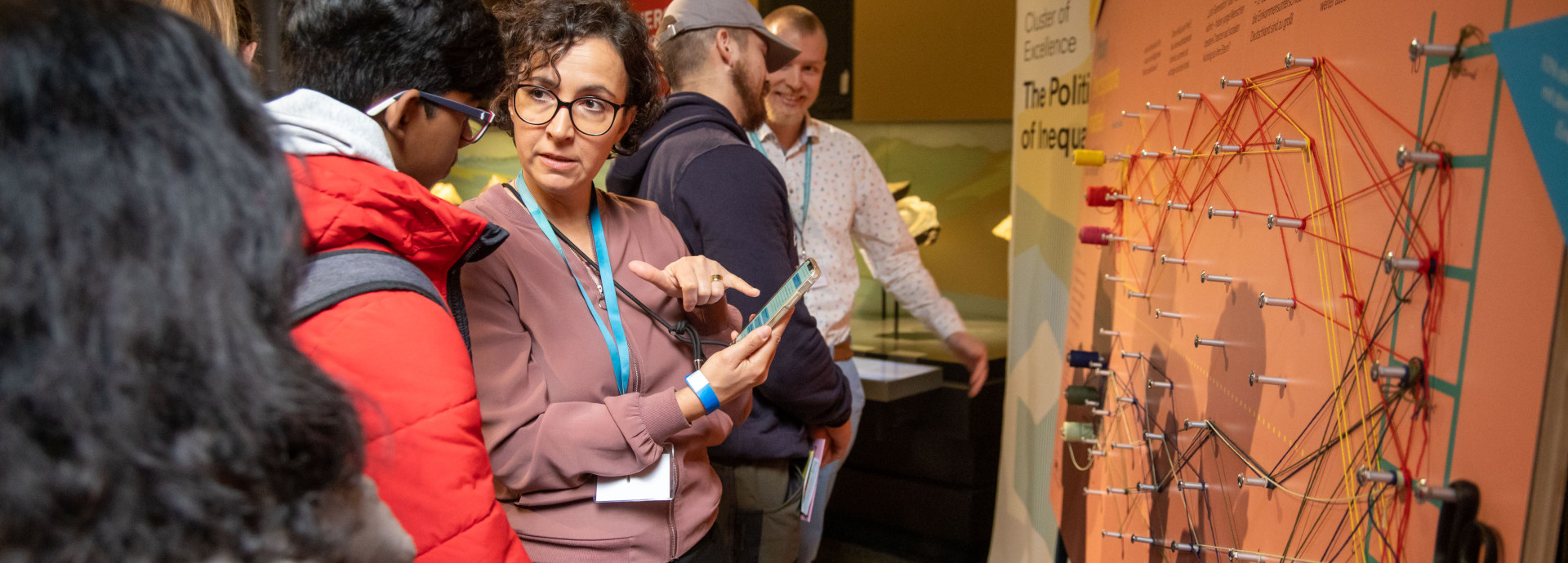 Am Stand des Exzellenzclusters auf der Berlin Science Week 2024 wird Besuchern das Projekt erklärt. 