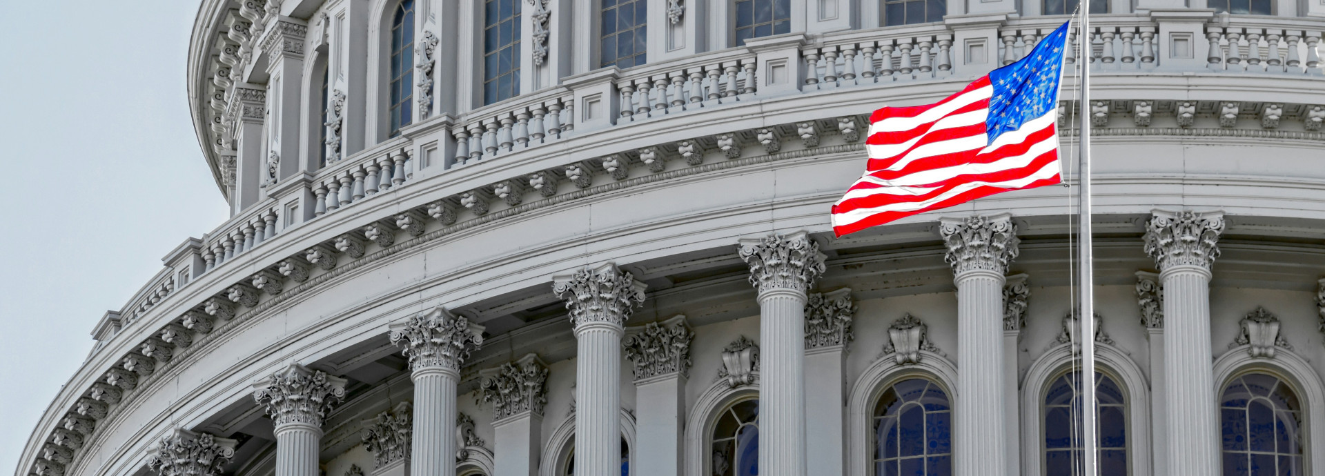 US flag flying on the US Capitol Building