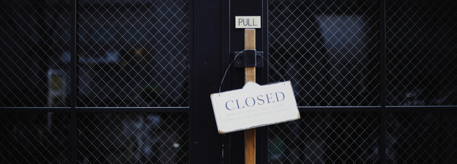 closed black metal door with the sign "closed"