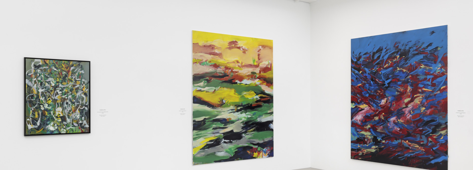 Colourful abstract paintings in gallery.