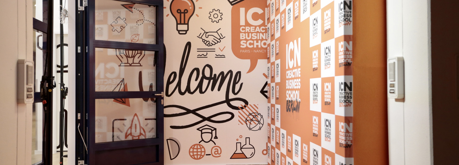 Open doors at ICN Berlin, with a welcome sign