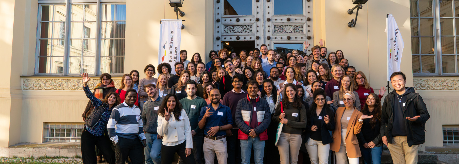 Group photo of Berlin Postdoc Day 2025 participants in front of the entrance of Humboldt Graduate School building