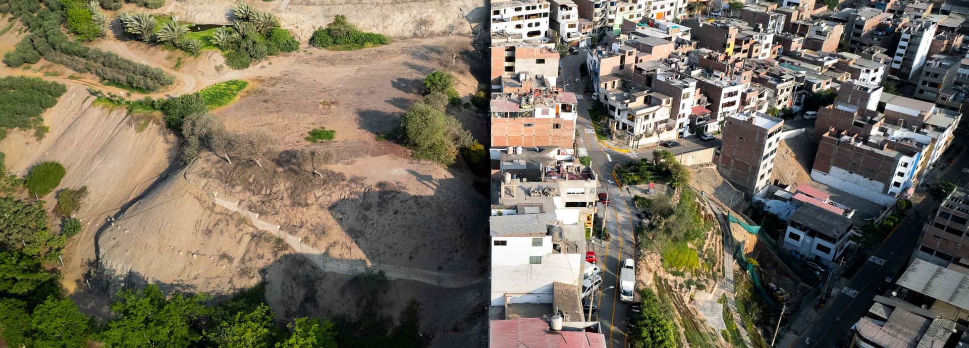 Densely packed homes across from a clean green park, separated by a fence. 