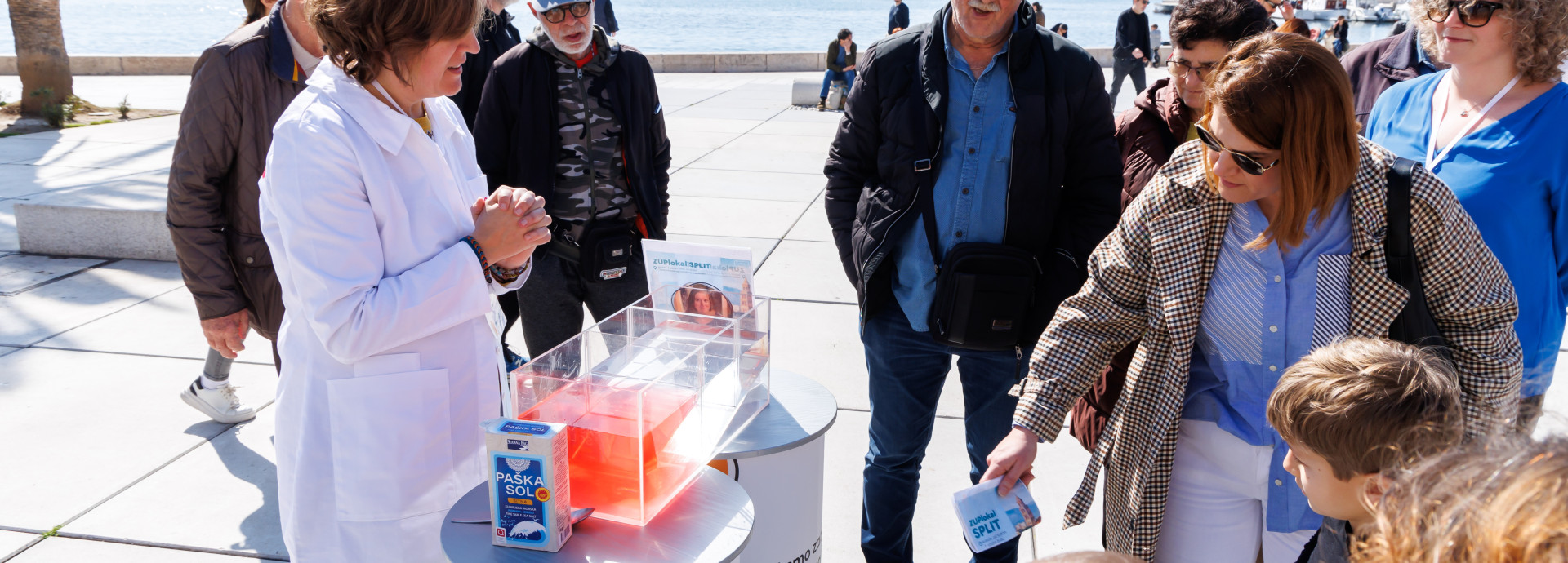 Scientist presenting work at a stand in a public place