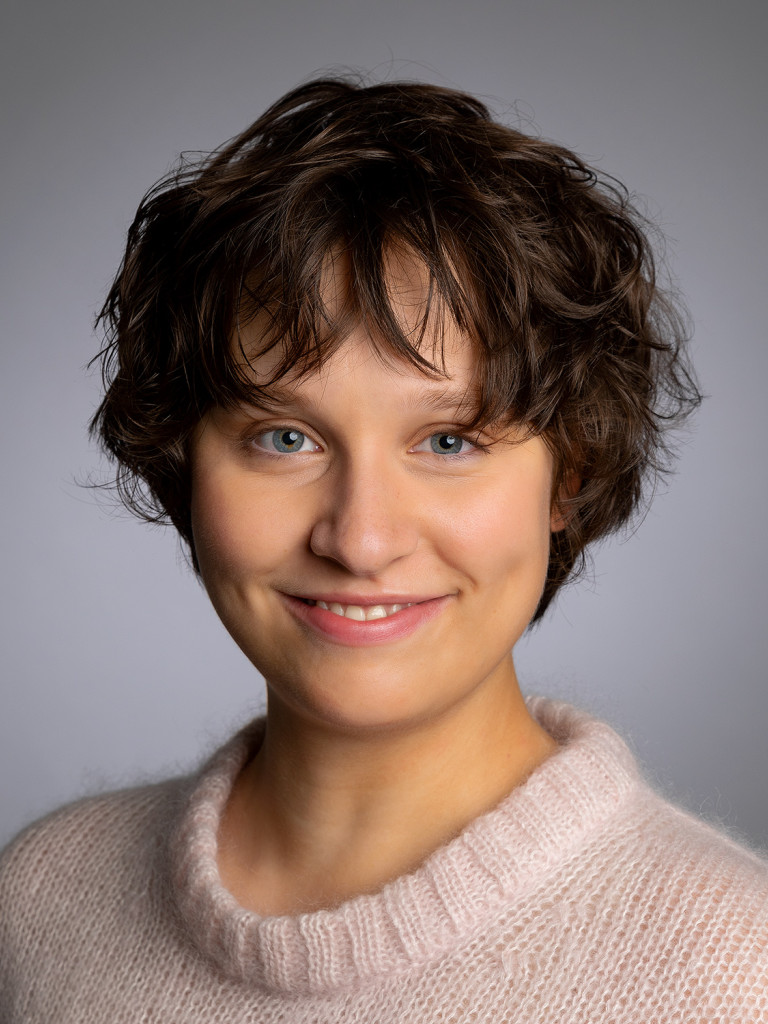 Lynn S. Guldin wearing a light coloured sweater, smiling at the camera.