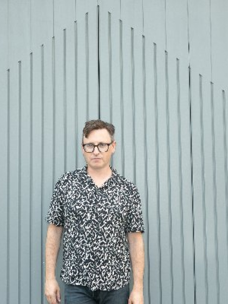 Dr Shane Regan standing against a grey background