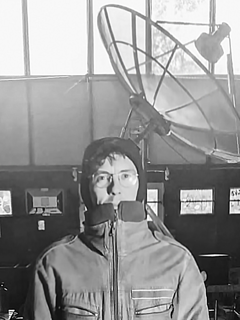 Artist in front of own radio telescope.