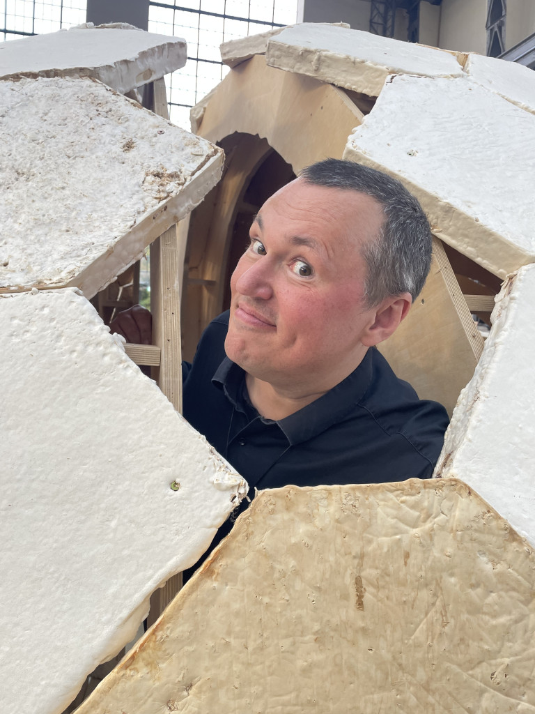 Man puts head out of mushroom house