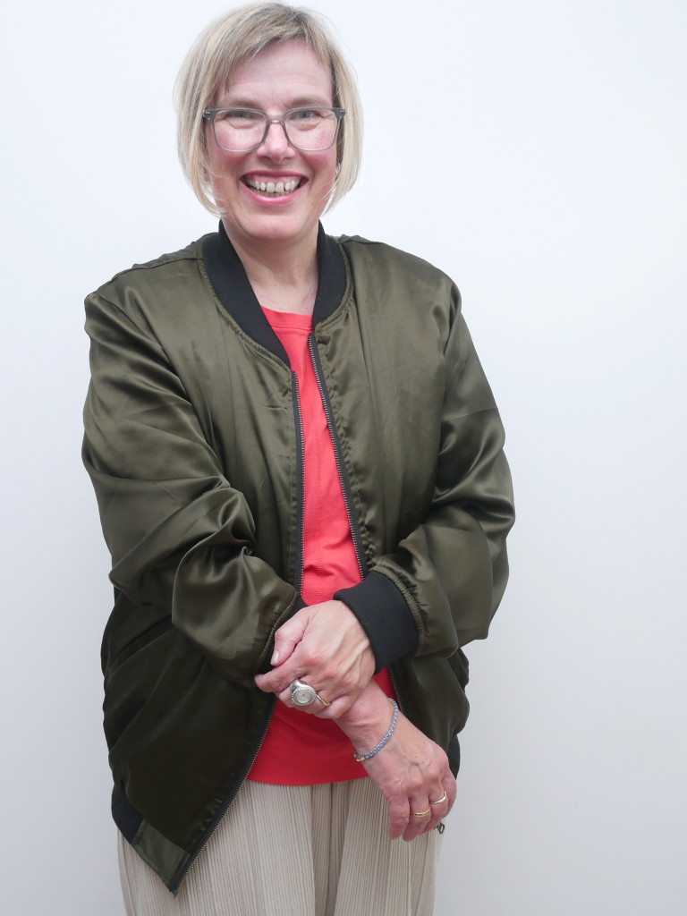 A smiling woman with glasses