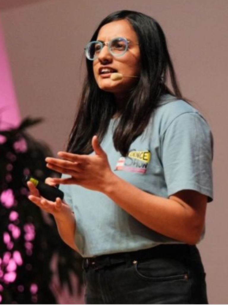 A woman with long dark hair giving a talk