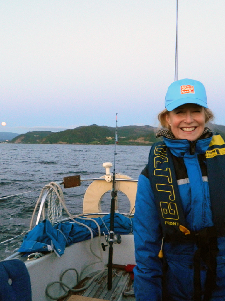 Woman smiling in a boat on the ocean