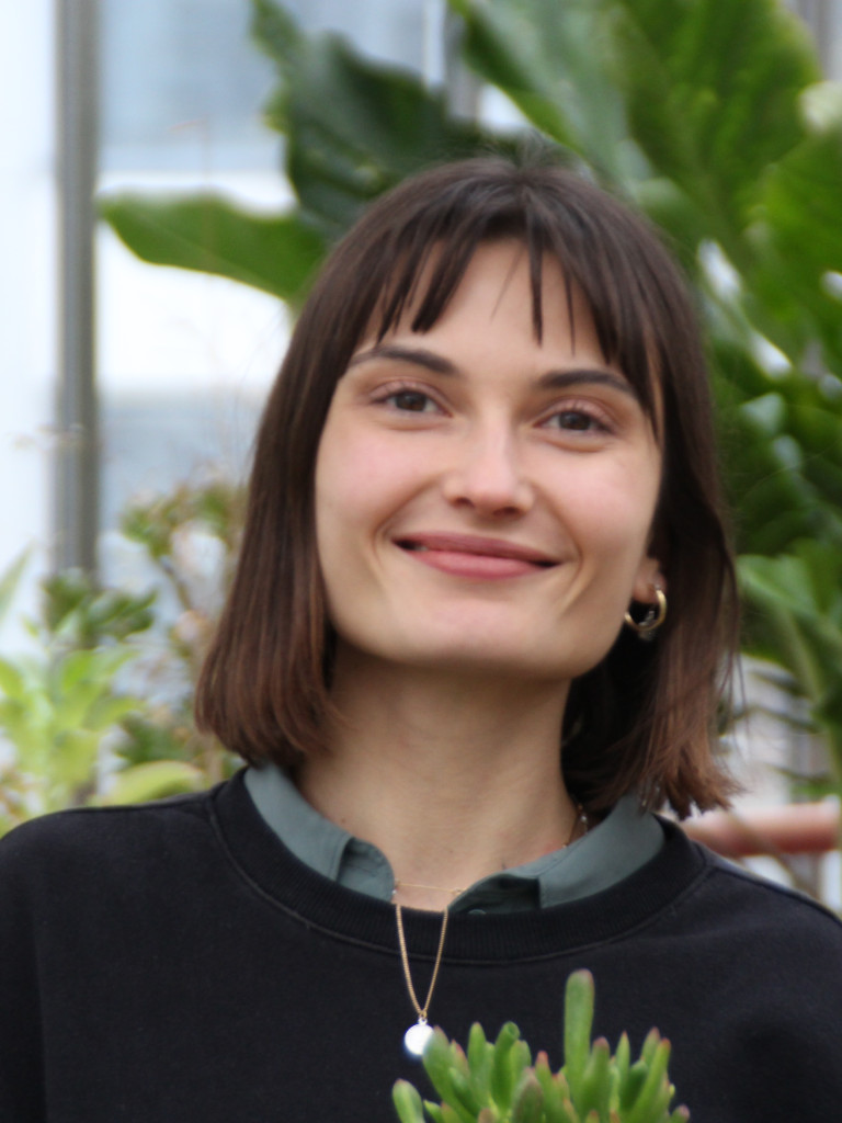 Image of woman who will run the workshop holding a plant.