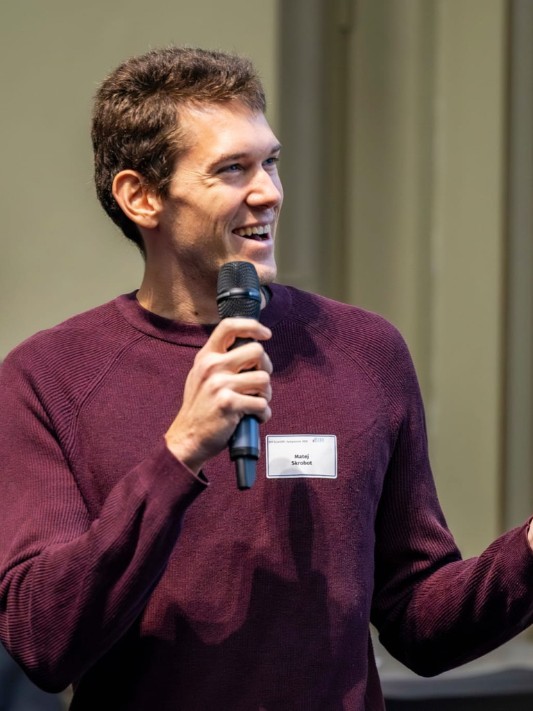 Matej speaking during a scientific event.