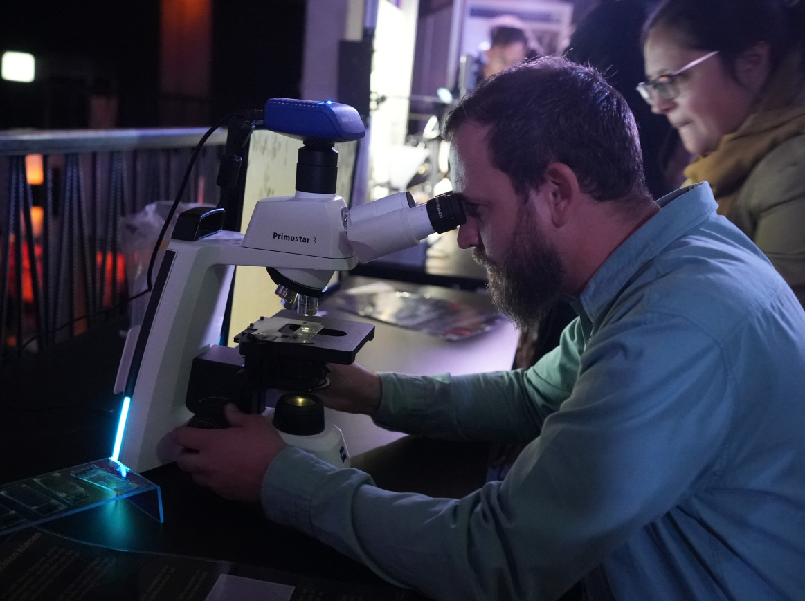 A man looking through a microscope