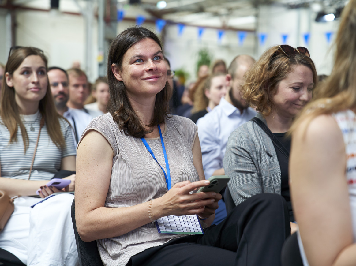 woman in the audience laughing 
