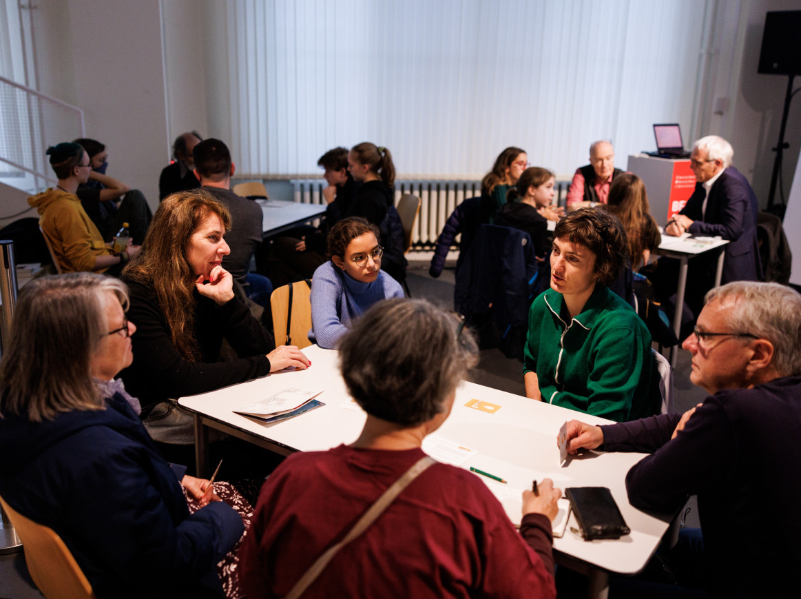 People sit in a group workshop.