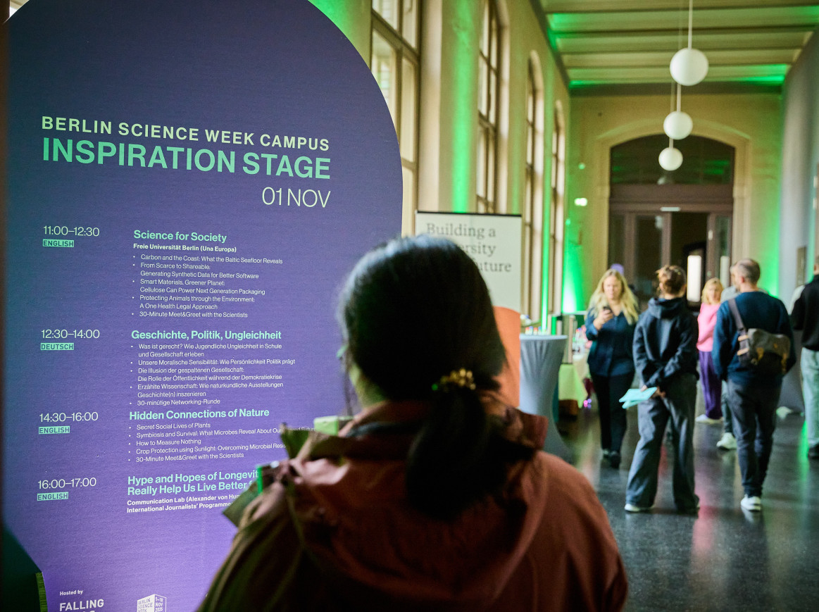 Someone stands in front of a sign that says Inspiration Stage 